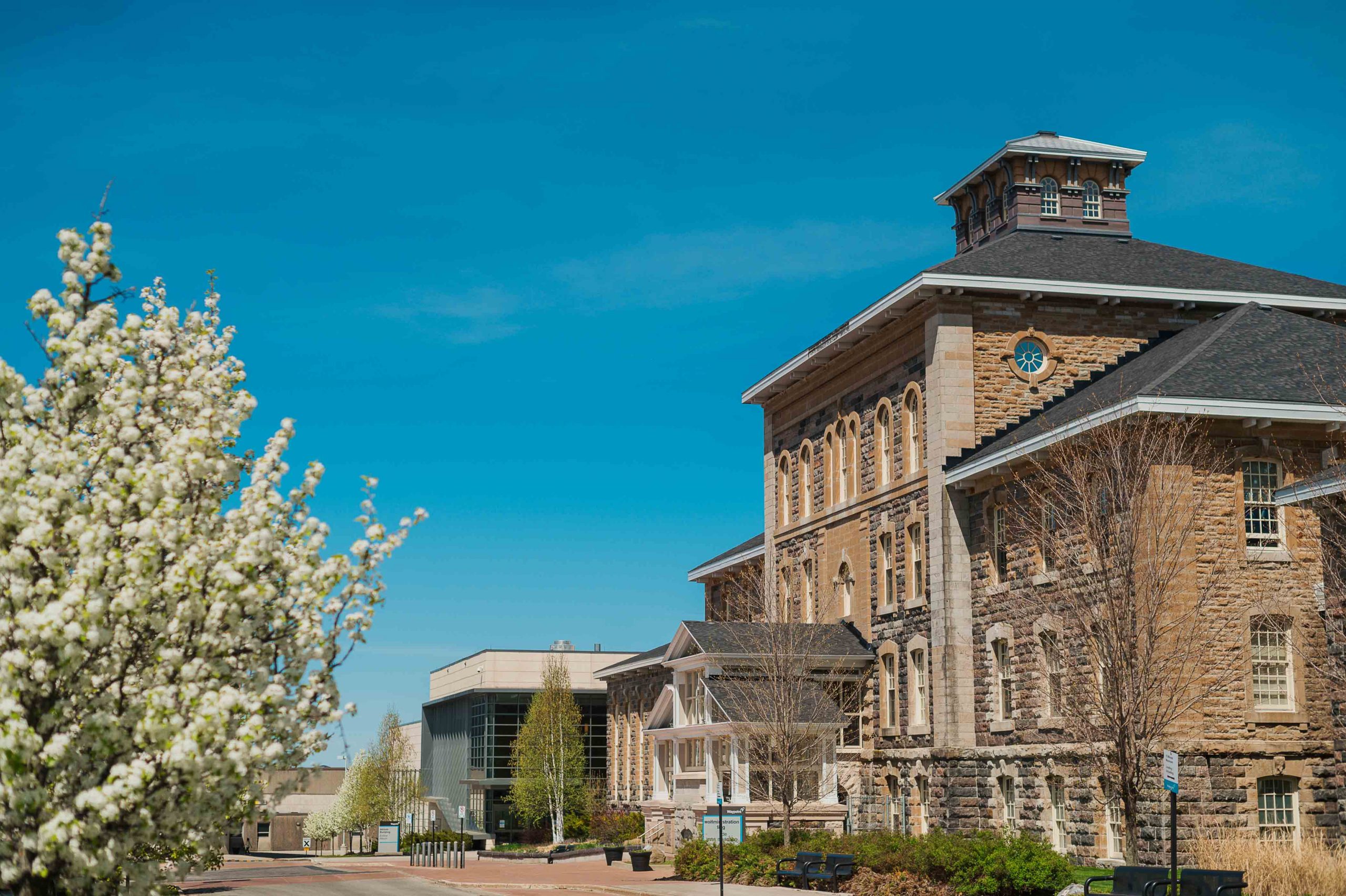 An exterior view of the Waypoint Centre for Mental Health Care with blooming trees surrounding.