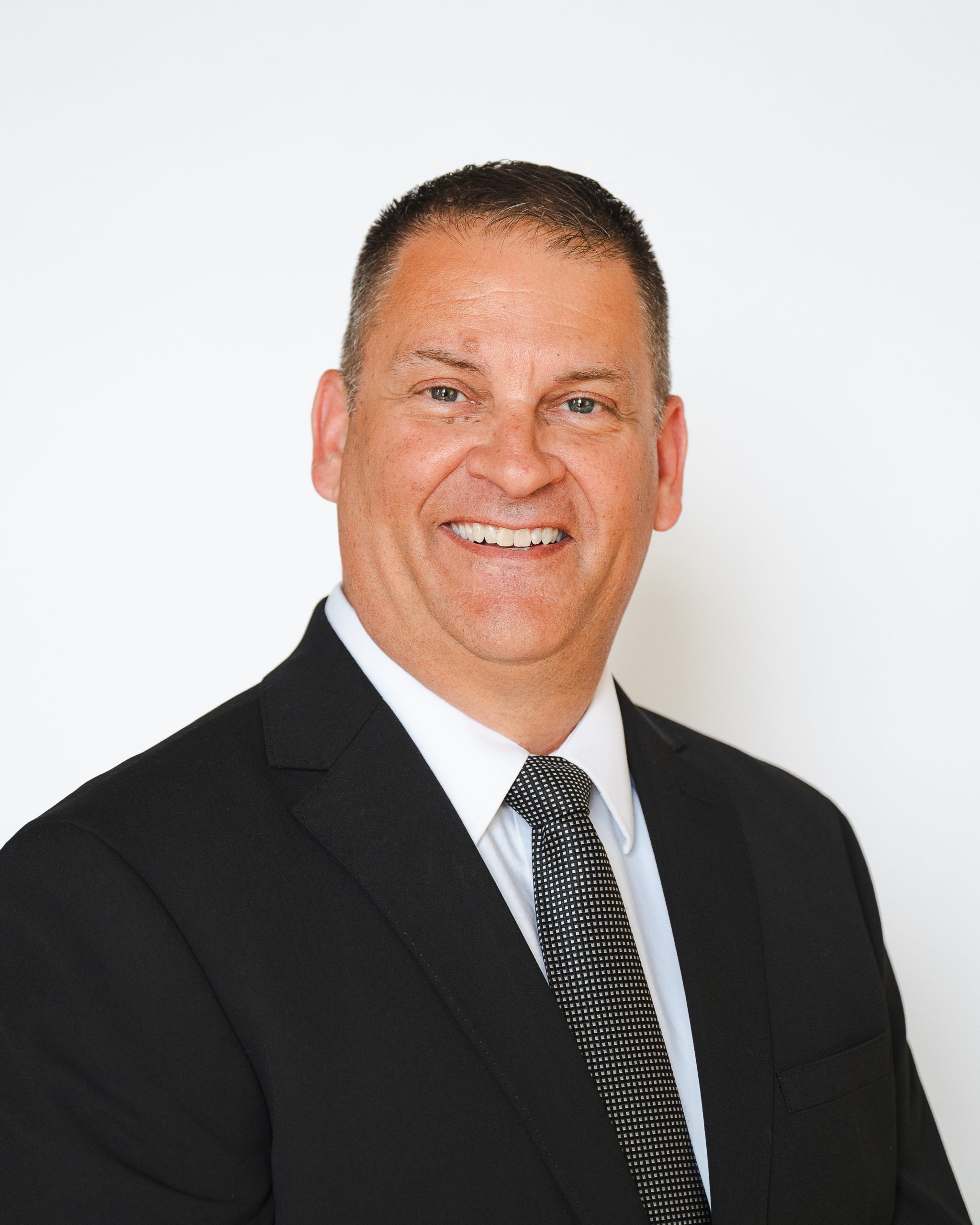 Headshot of Rob Desroches on white background.