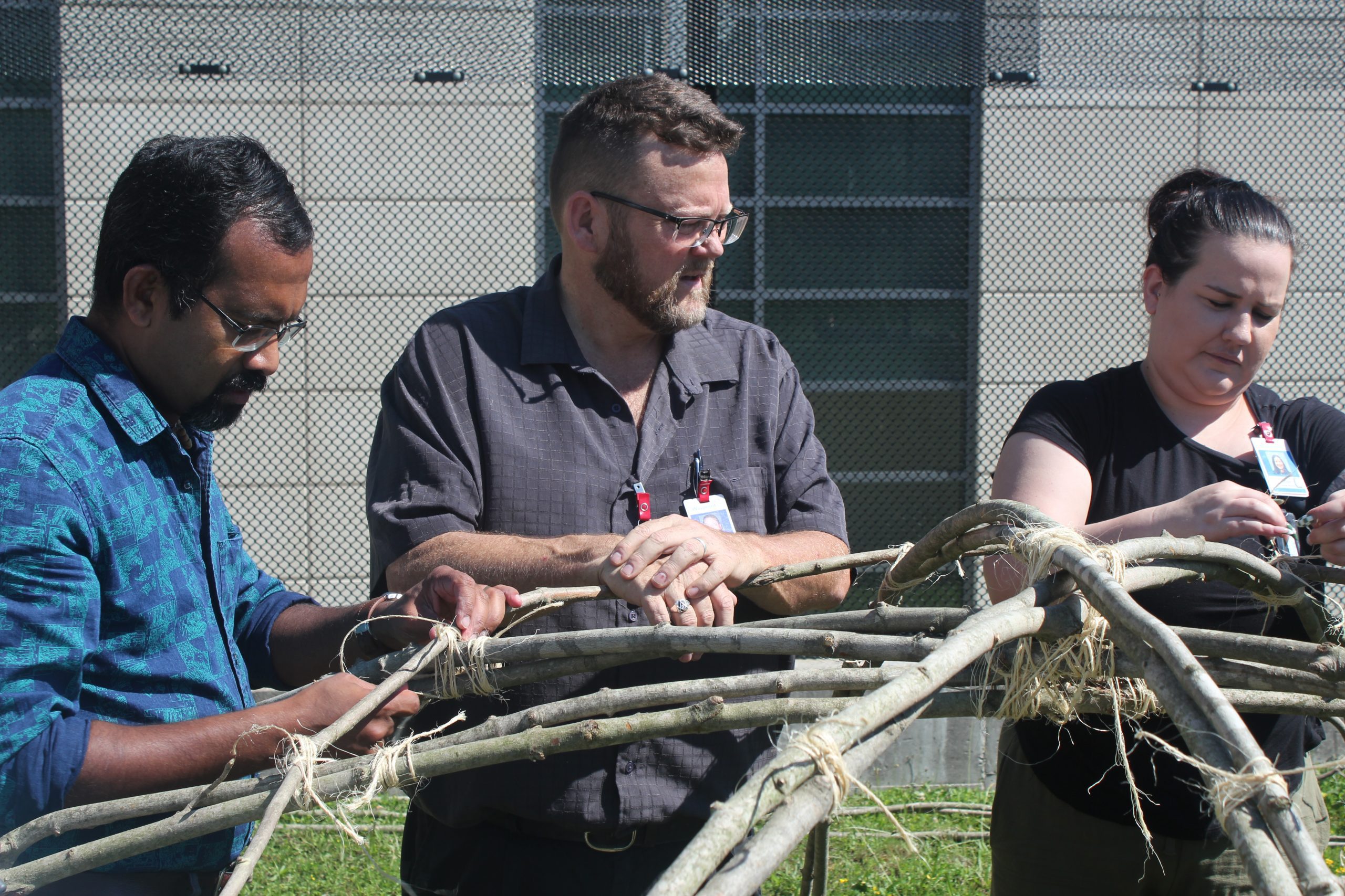 Three Waypoint staff members building a sweat lodge.