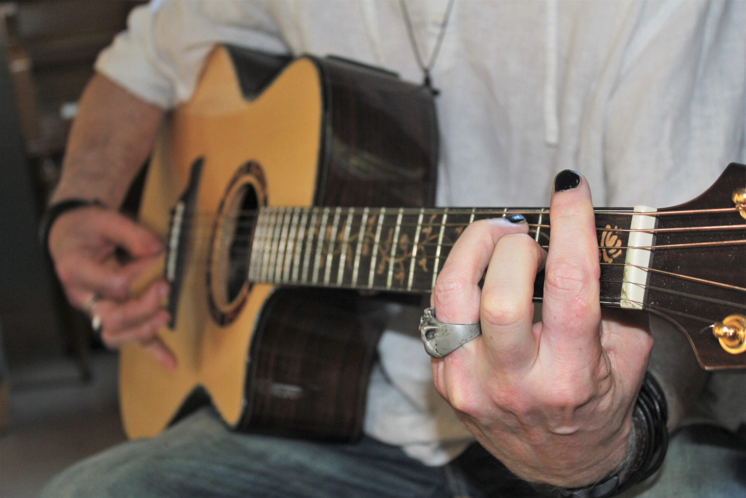 Close up of a patient playing their guitar